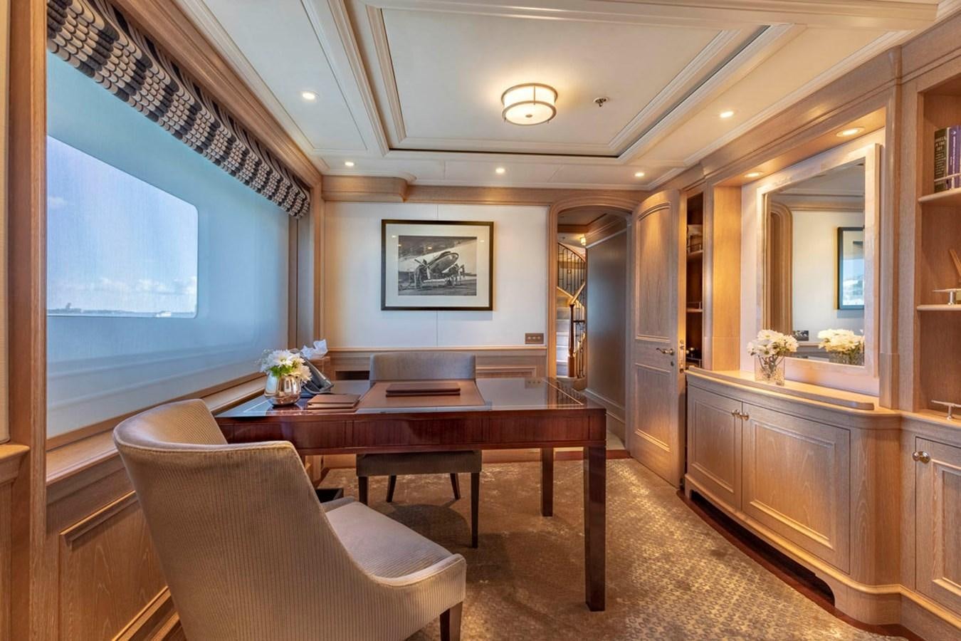 a large room with a table and chairs aboard FABULOUS CHARACTER Yacht for Sale