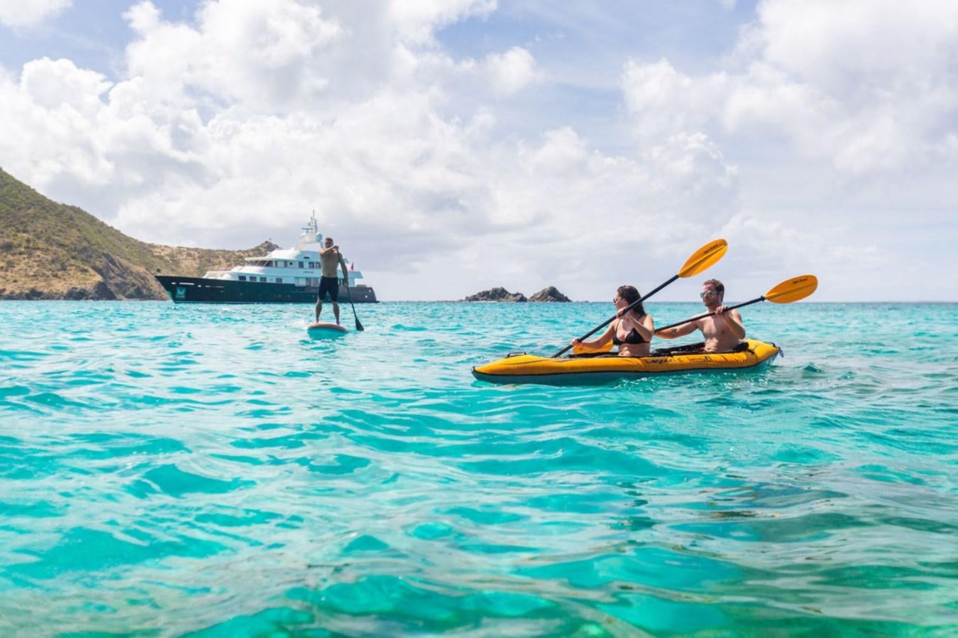 a group of people in a canoe on the water aboard FABULOUS CHARACTER Yacht for Sale