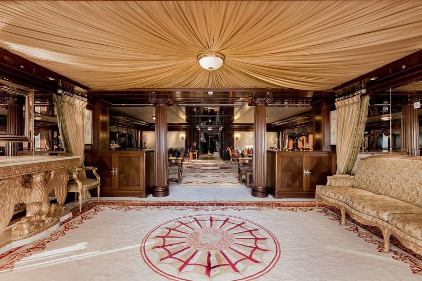 a large room with a couch and a rug aboard PURE Yacht for Sale