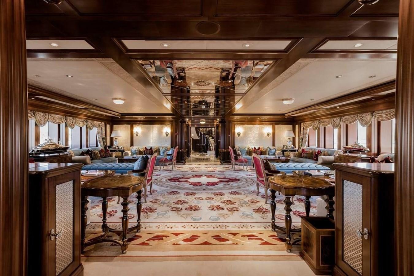 a large room with a table and chairs aboard PURE Yacht for Sale