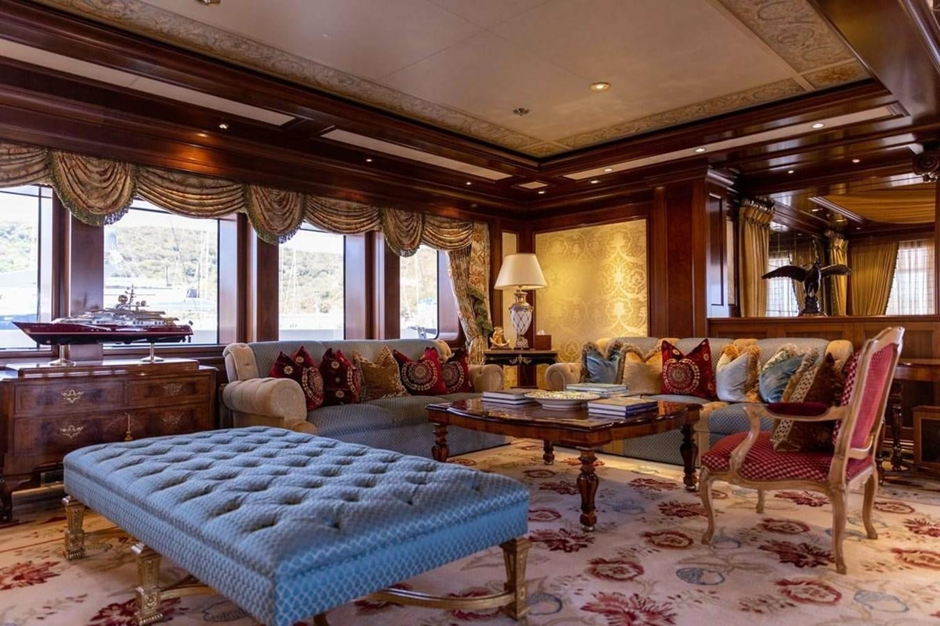 a living room with a blue rug aboard PURE Yacht for Sale