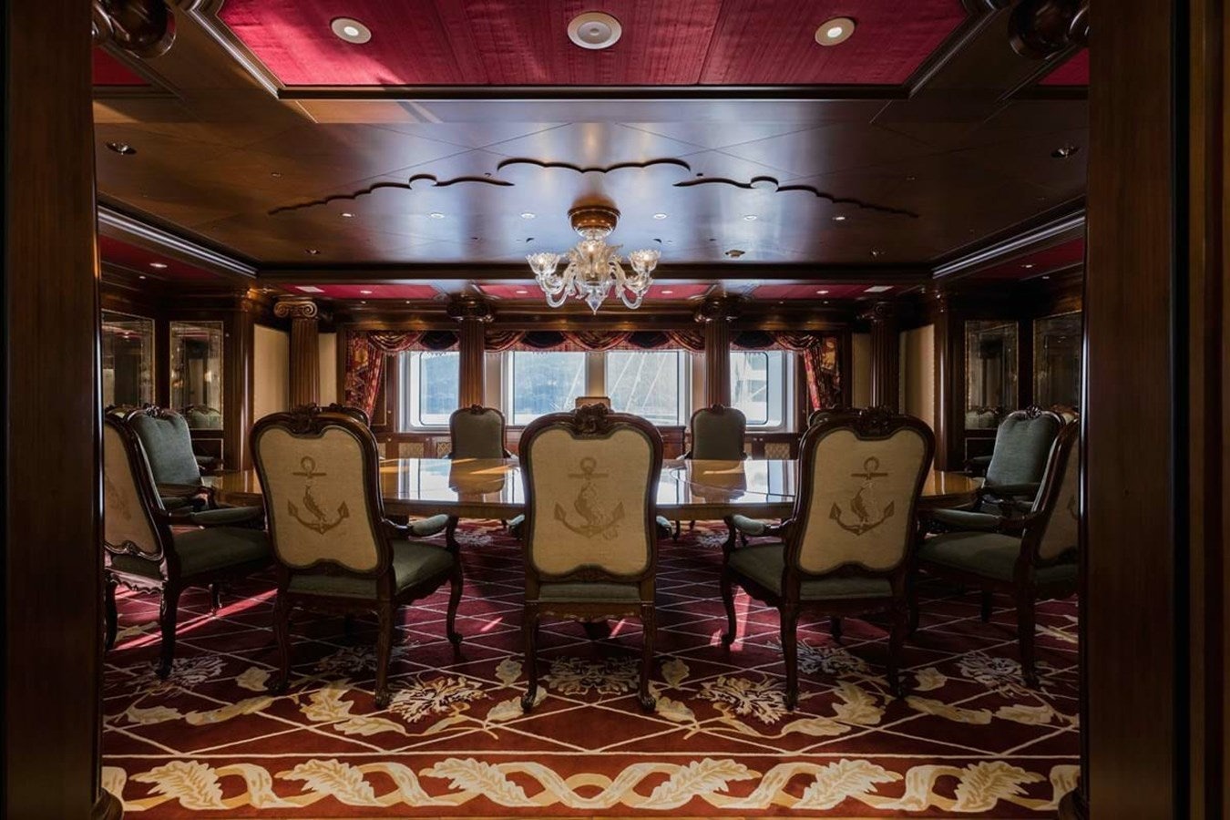 a room with chairs and a chandelier aboard PURE Yacht for Sale