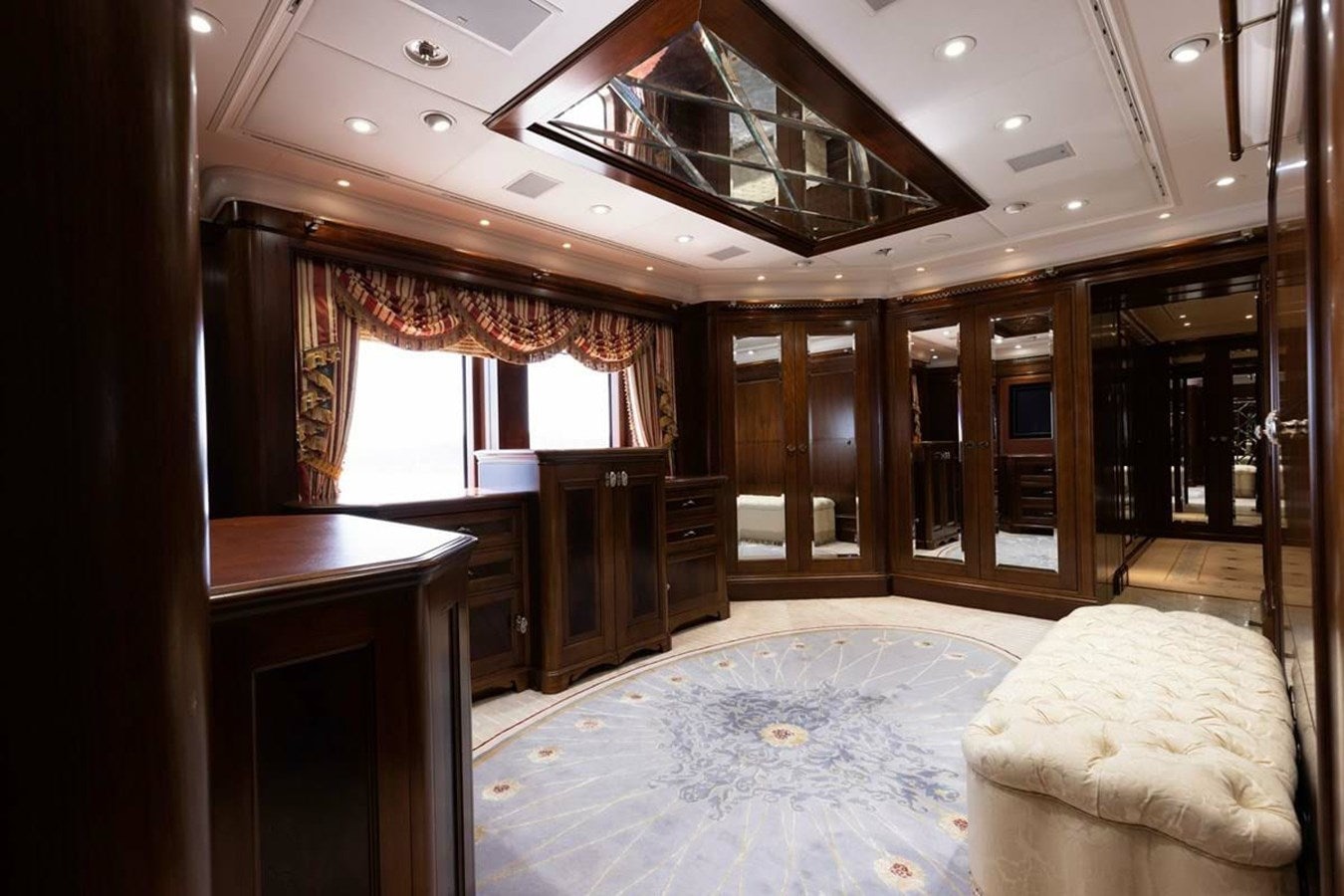 a room with a bed and a table aboard PURE Yacht for Sale