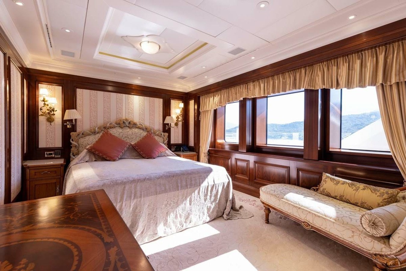 a large bedroom with a bed and a couch aboard PURE Yacht for Sale