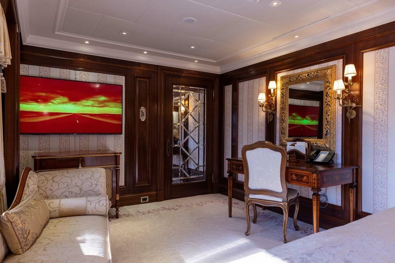 a bedroom with a tv and a bed aboard PURE Yacht for Sale