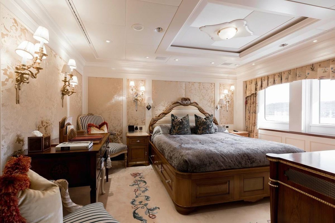 a bedroom with a bed and a desk aboard PURE Yacht for Sale