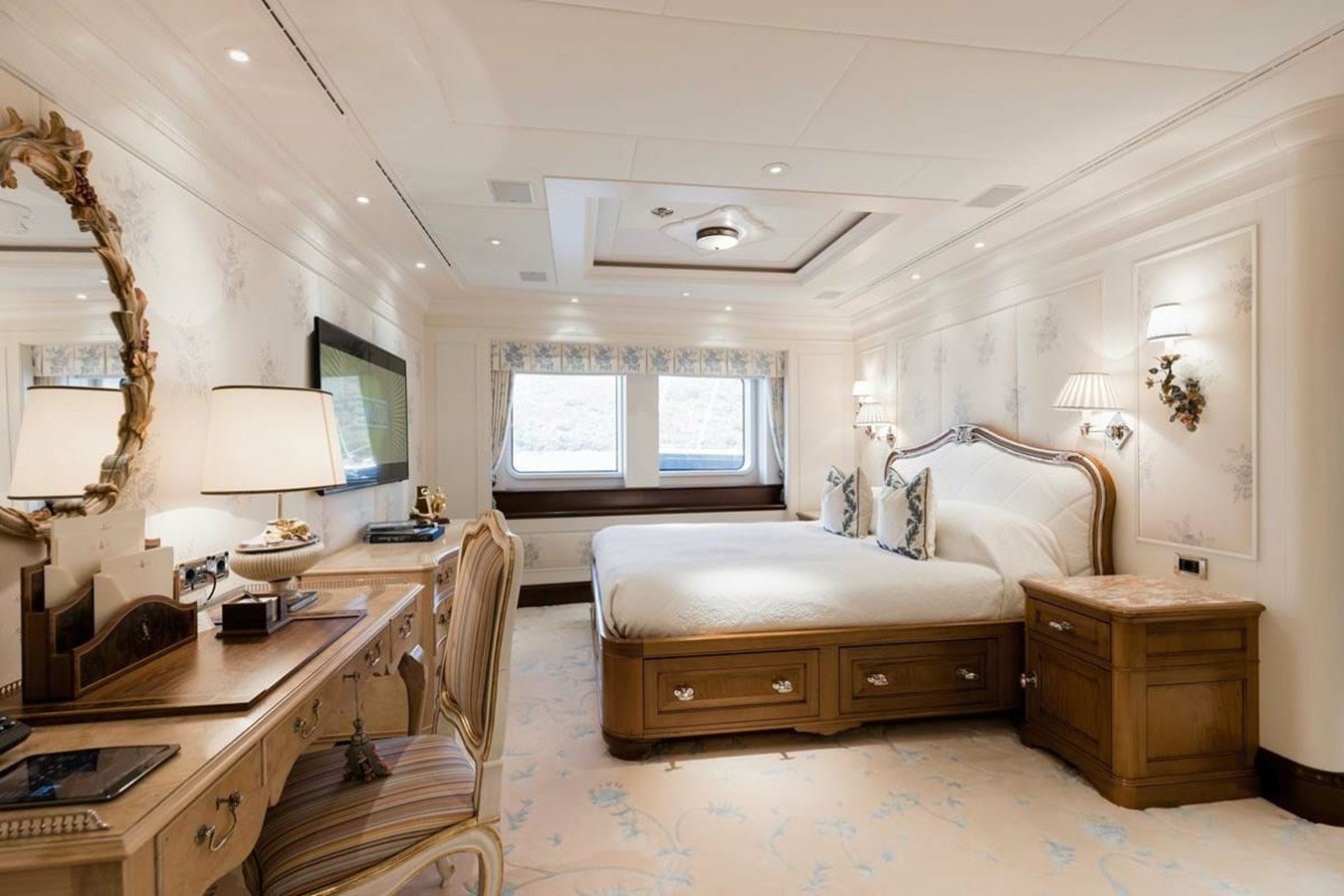 a bedroom with a bed desk and a desk aboard PURE Yacht for Sale