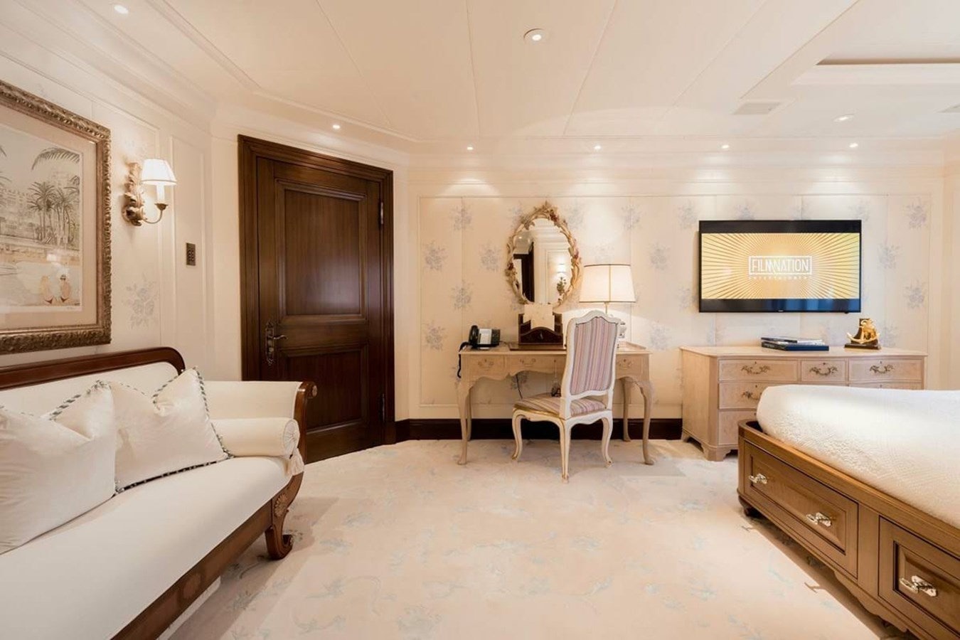 a room with a bed and a desk aboard PURE Yacht for Sale