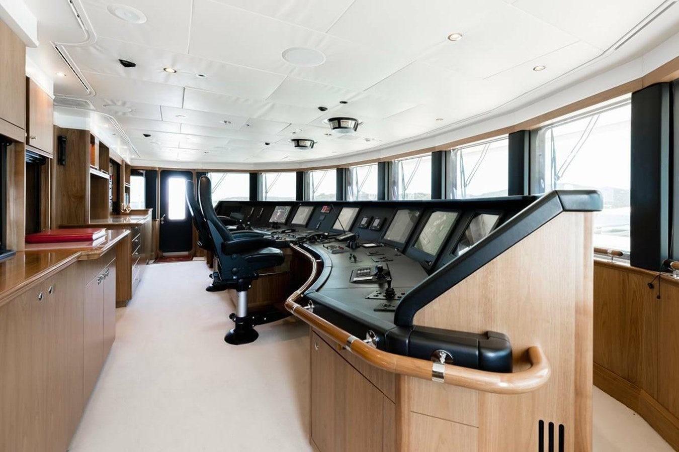 a room with a desk and chairs aboard PURE Yacht for Sale