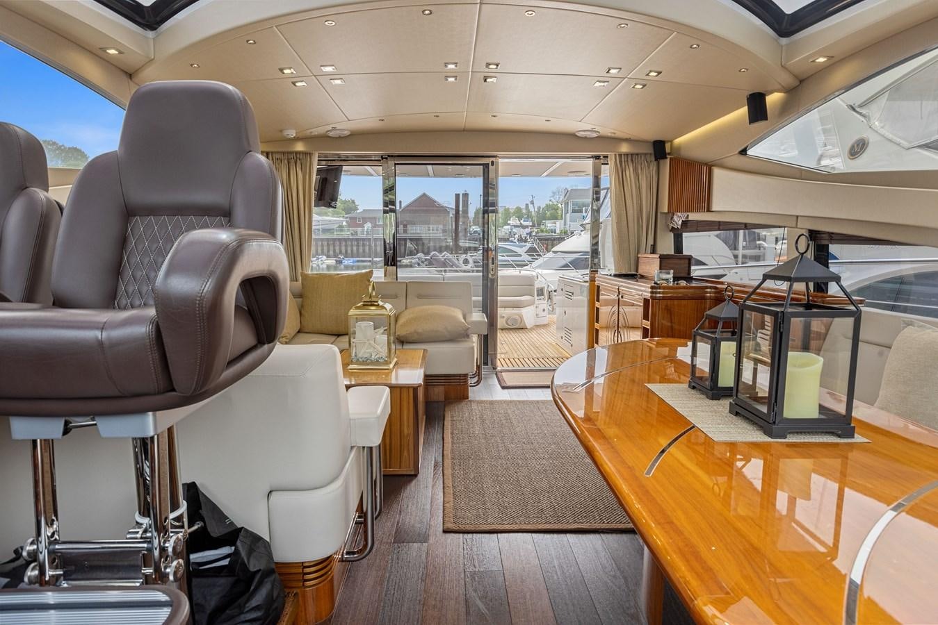 inside of a vehicle with a desk and chairs and a large window aboard DIGGIN Yacht for Sale