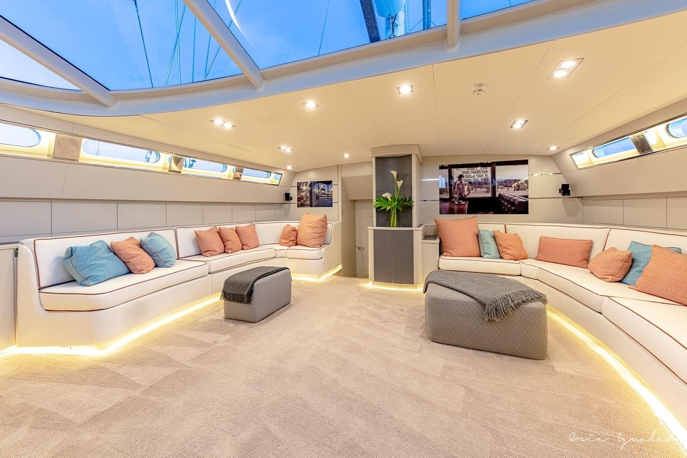 a large room with a couch and a fireplace aboard MY STAR Yacht for Sale