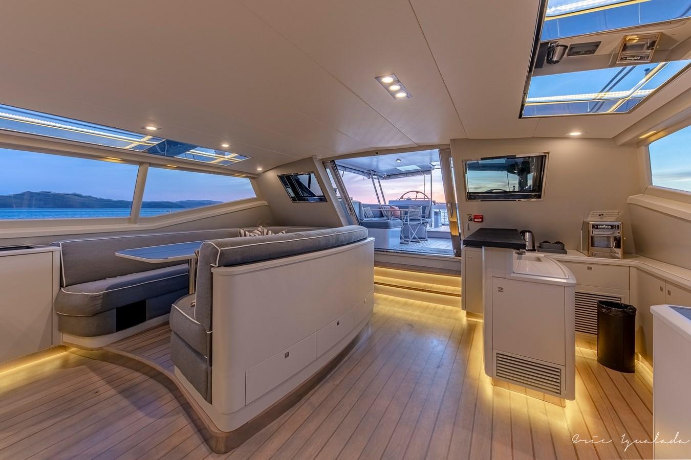 a room with a large window and a wood floor aboard MY STAR Yacht for Sale