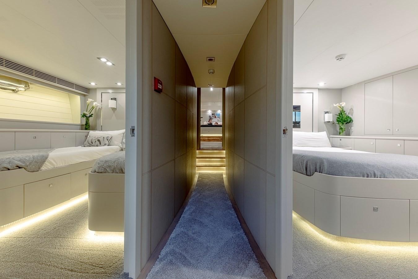 a room with a bed and a blue rug aboard MY STAR Yacht for Sale