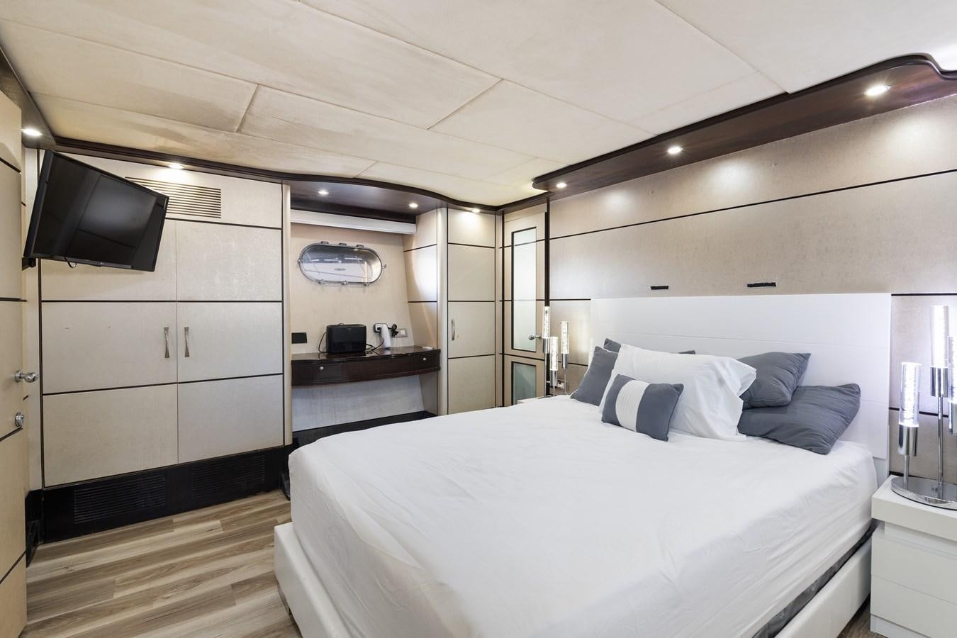 a bedroom with a bed and a television aboard NIRVANA Yacht for Sale
