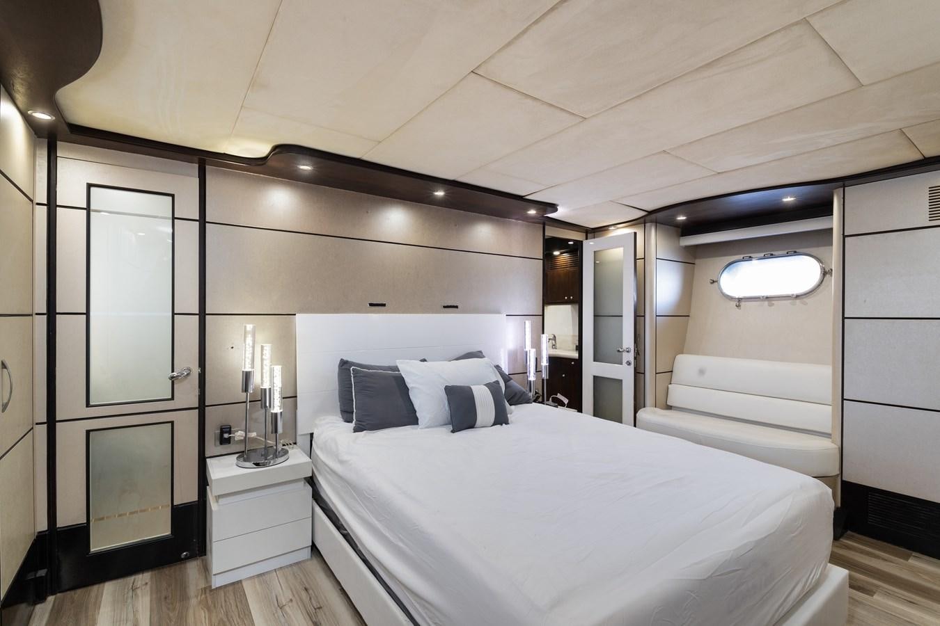 a bedroom with a bed and a mirror aboard NIRVANA Yacht for Sale