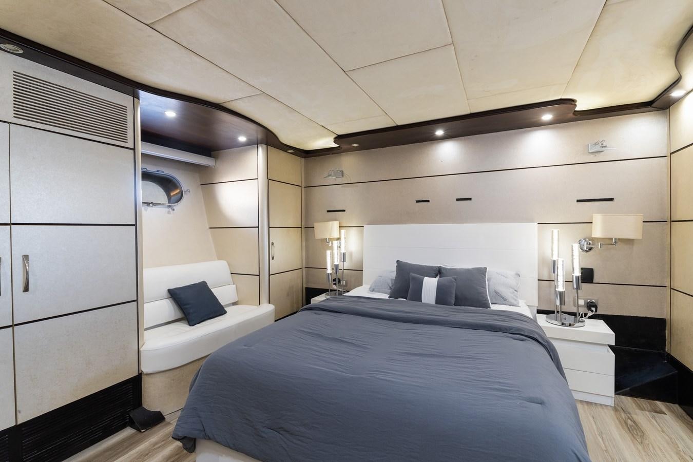 a bedroom with a bed and a desk aboard NIRVANA Yacht for Sale