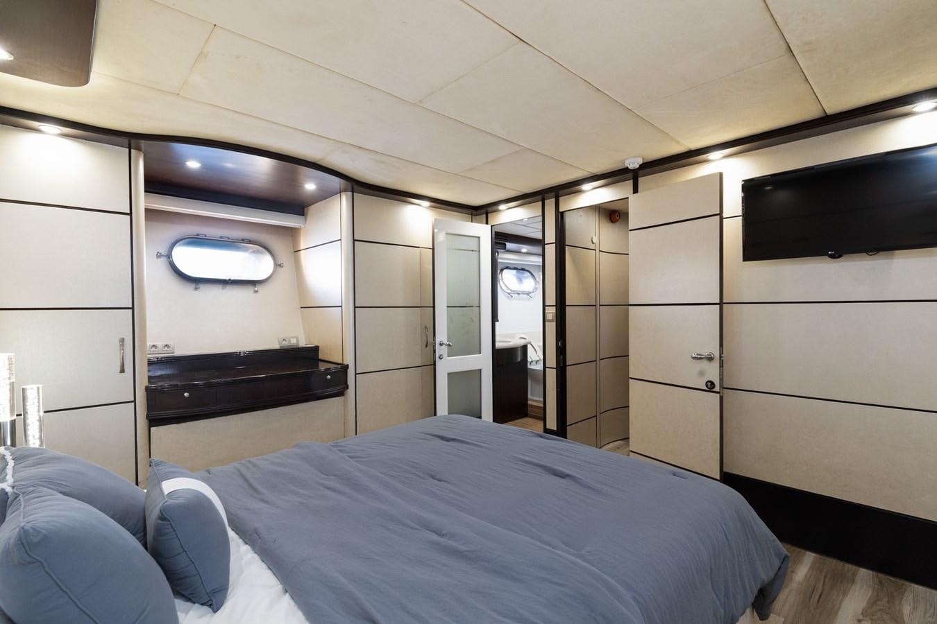 a room with a bed and a mirror aboard NIRVANA Yacht for Sale