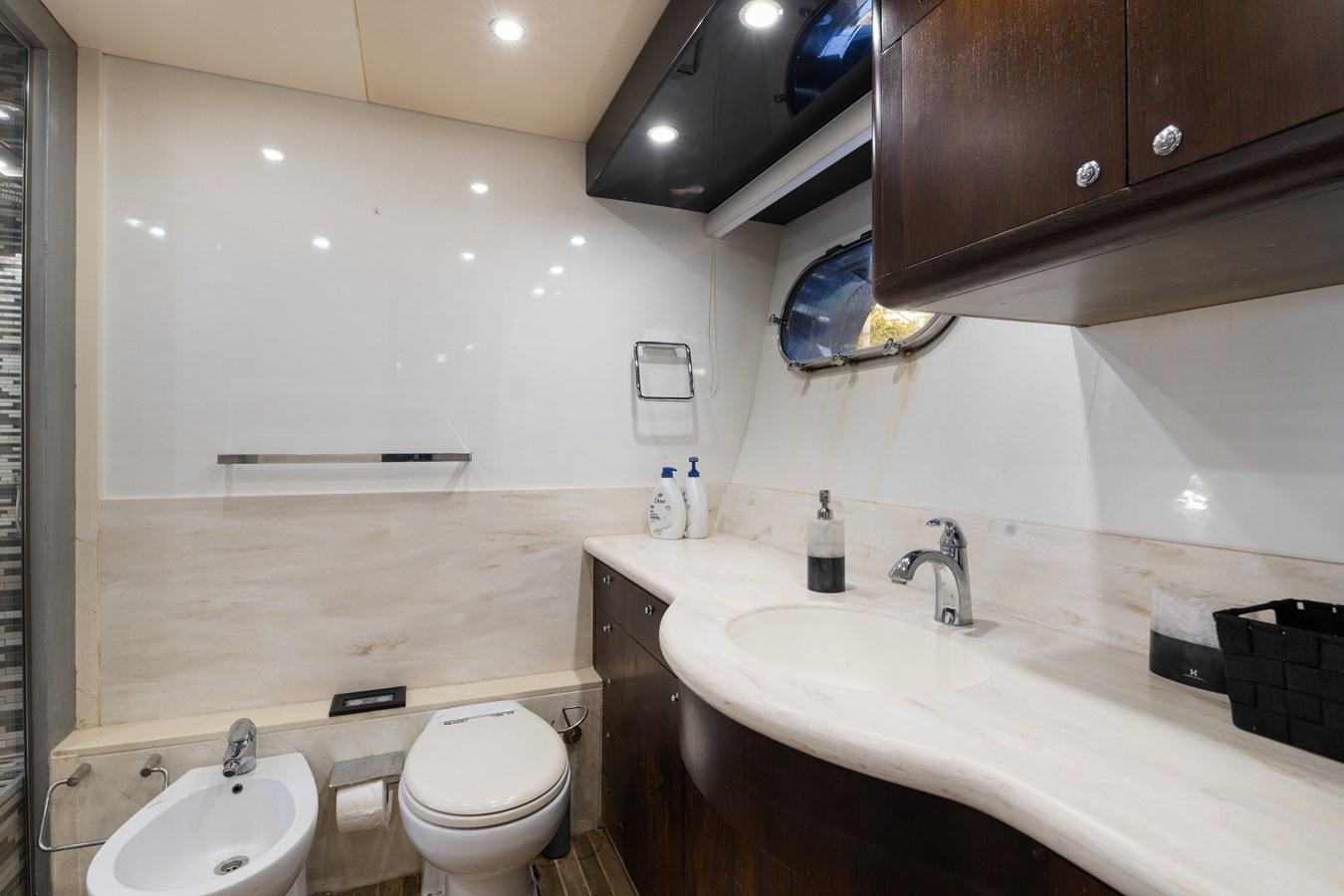 a bathroom with a sink toilet and a mirror aboard NIRVANA Yacht for Sale