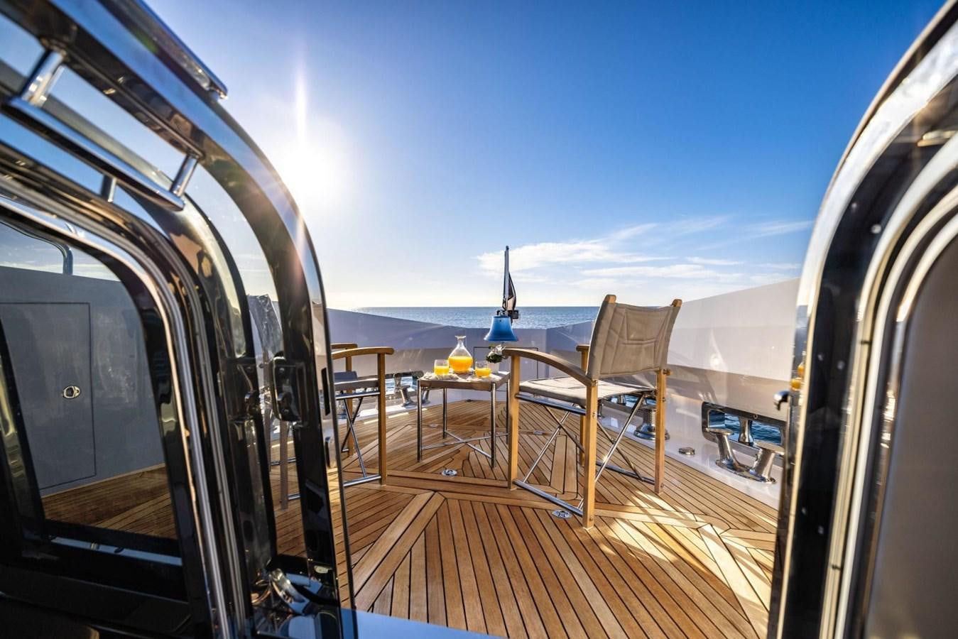 a deck with a table and chairs on it aboard SUNSEEKER 100 Yacht for Sale