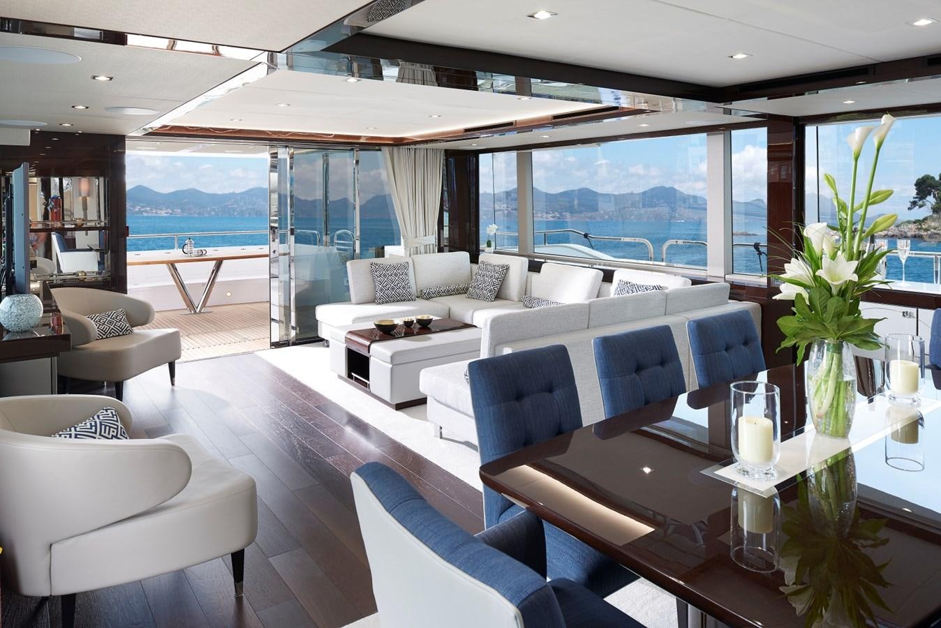 a room with a table chairs and a vase with flowers in it aboard 95 YACHT Yacht for Sale