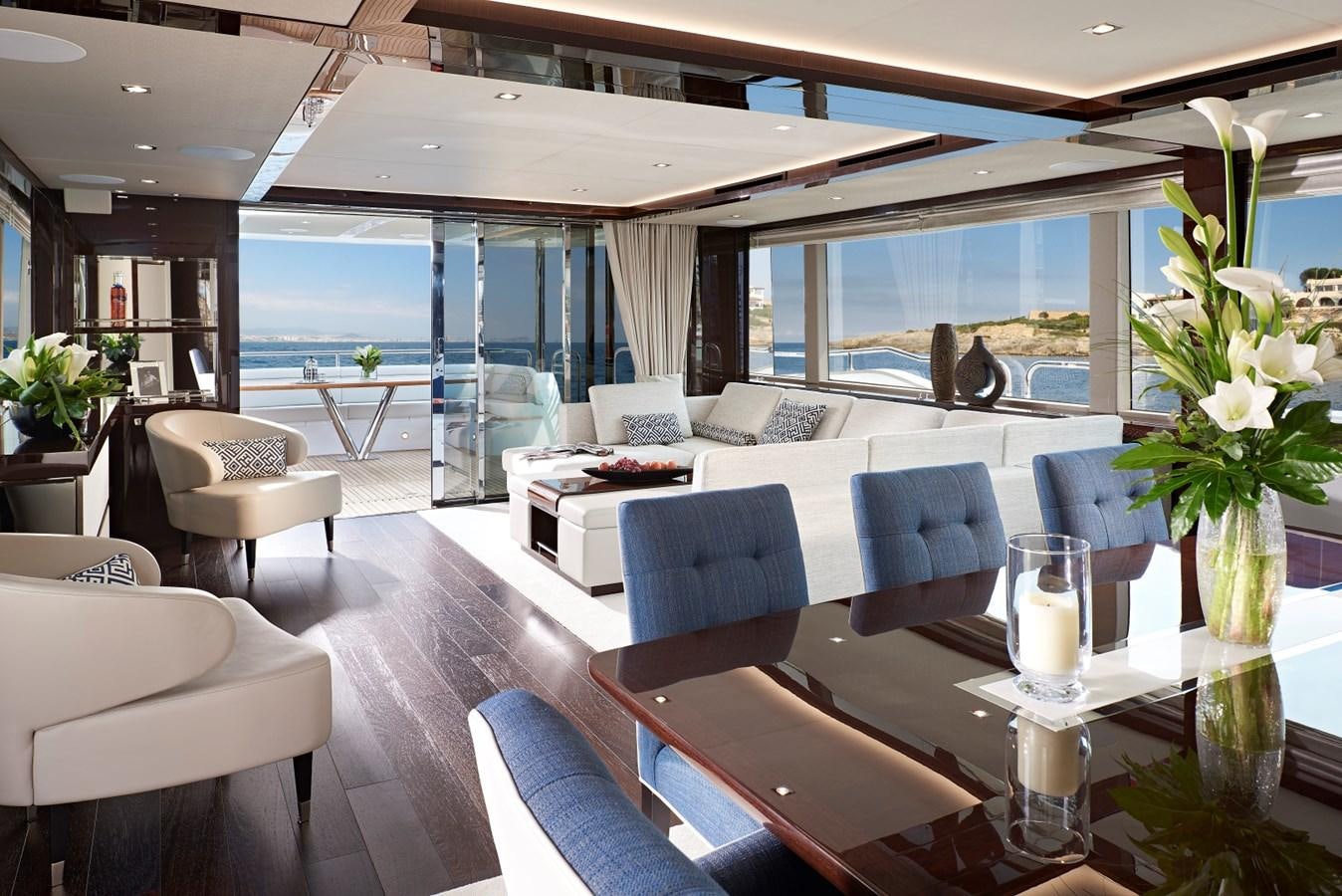 a room with a table chairs and a view of the ocean aboard 95 YACHT Yacht for Sale