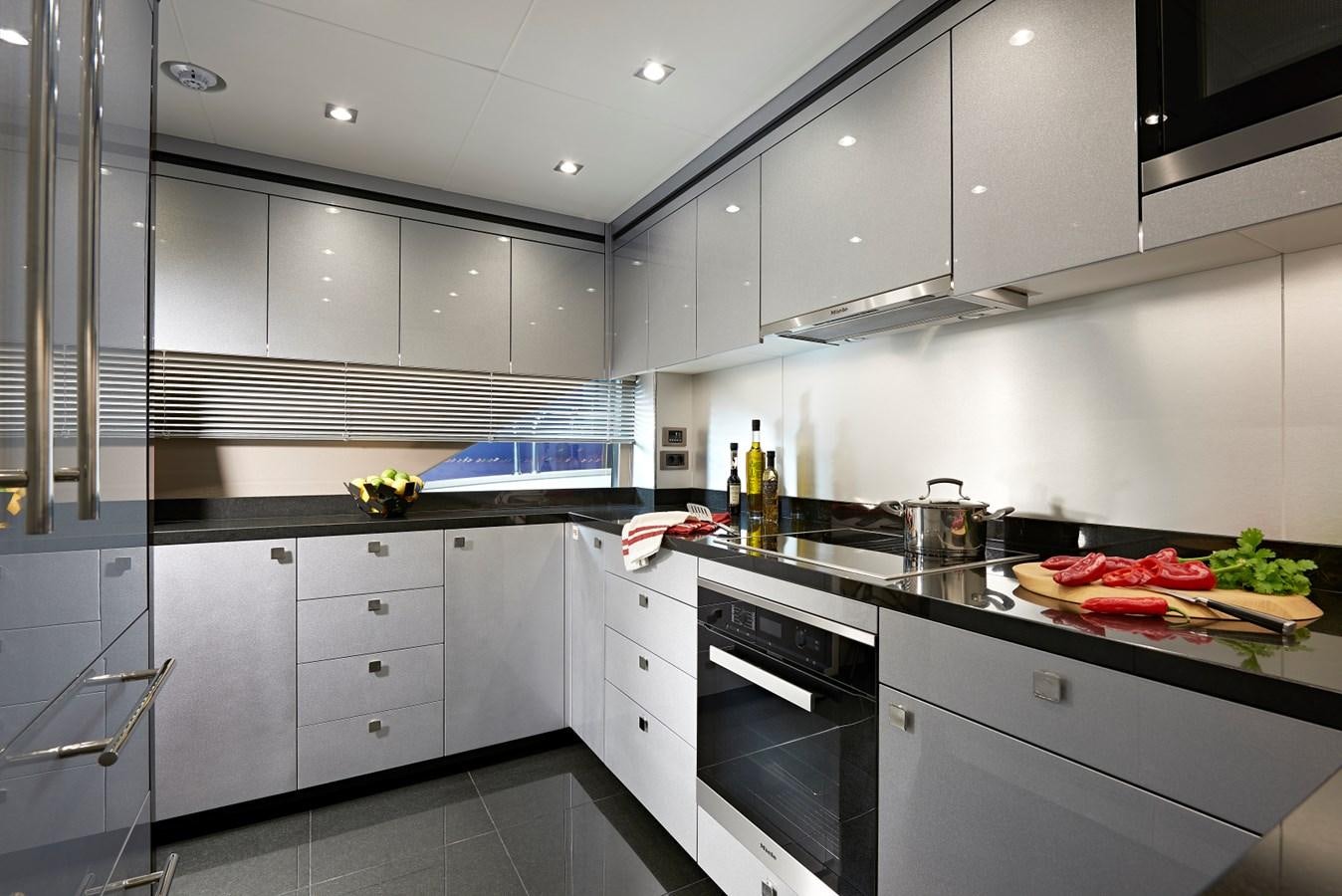 a kitchen with white cabinets aboard 95 YACHT Yacht for Sale