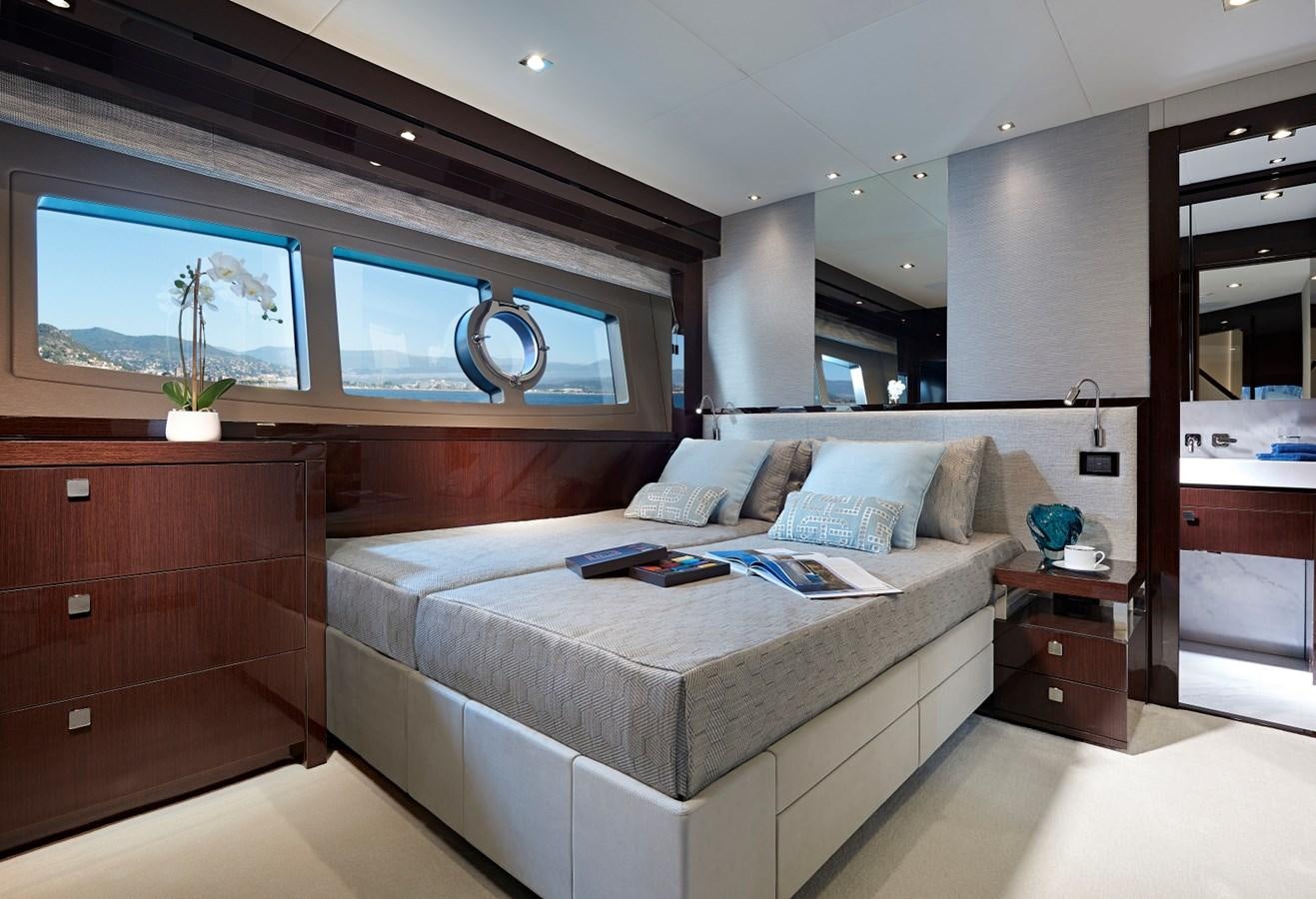 a bedroom with a bed and a desk aboard 95 YACHT Yacht for Sale