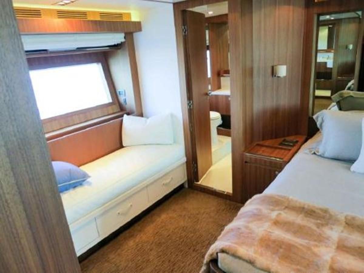 a bedroom with a bed and a mirror aboard PRIVILEGIO Yacht for Sale