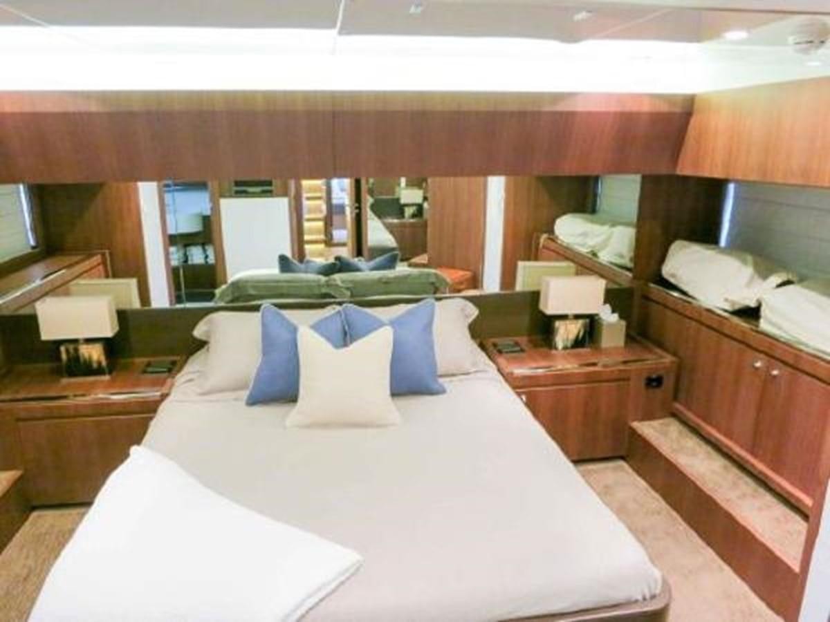 a room with a bed and a desk aboard PRIVILEGIO Yacht for Sale