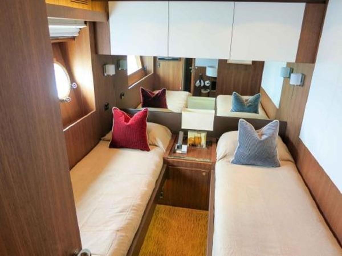 a room with a bed and a desk aboard PRIVILEGIO Yacht for Sale