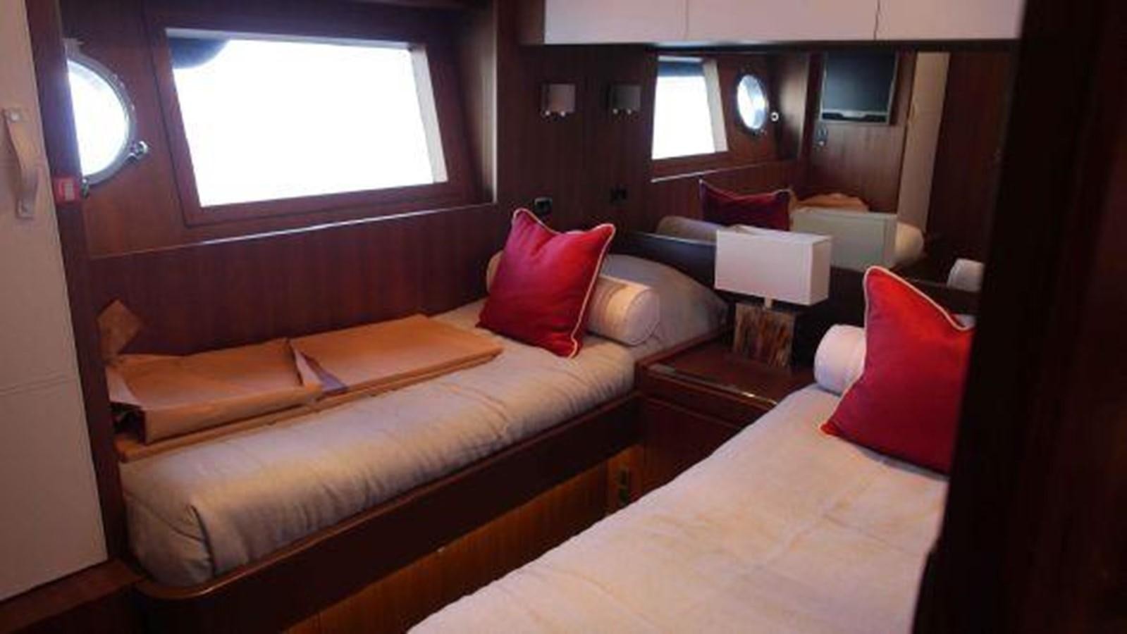 a living room with a bed and a window aboard PRIVILEGIO Yacht for Sale