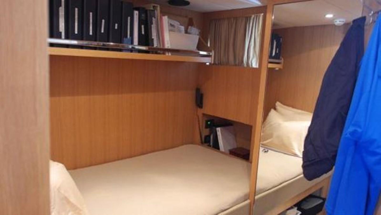 a room with a bed and a bookcase aboard PRIVILEGIO Yacht for Sale