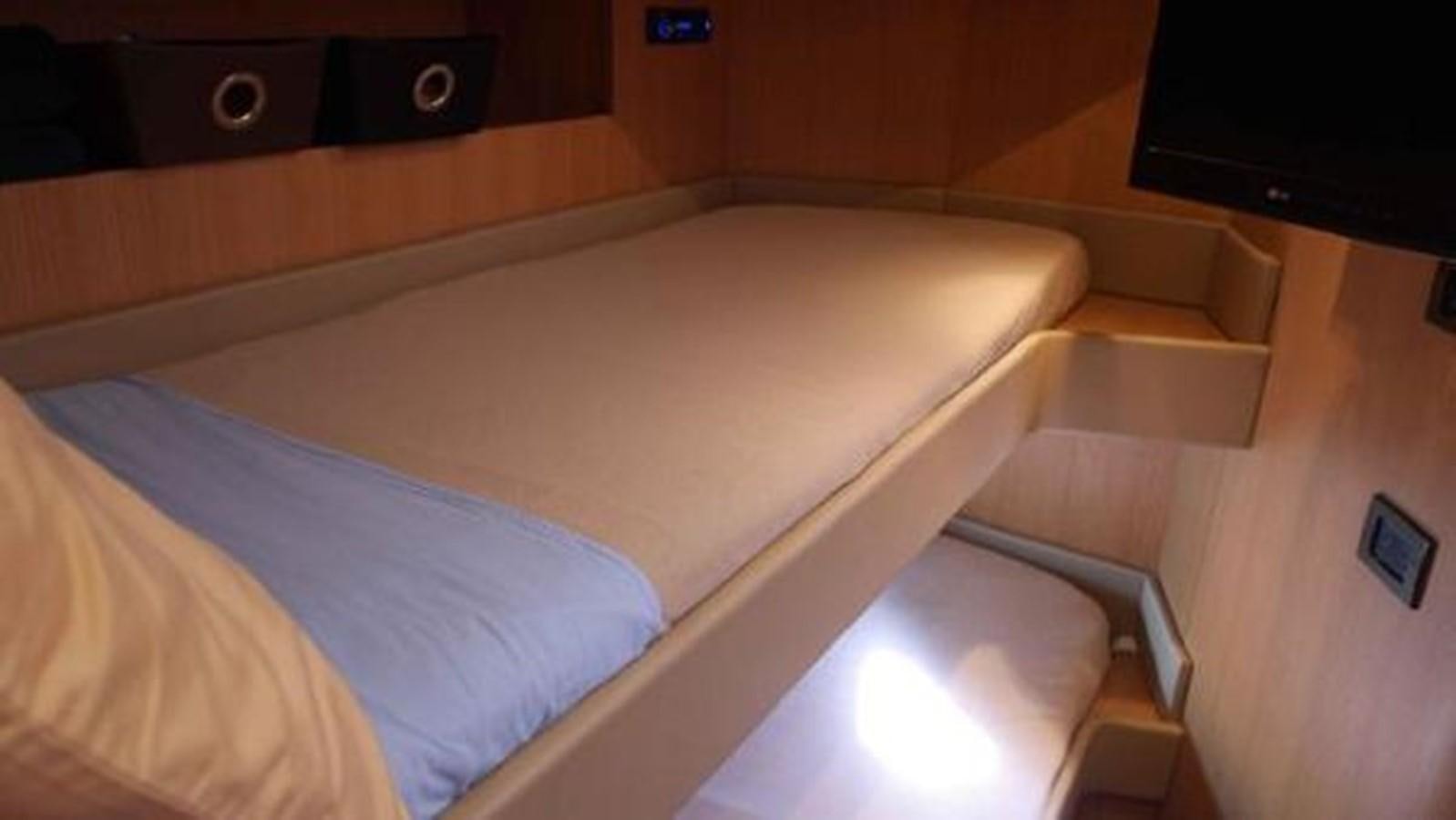 a bed with a white sheet aboard PRIVILEGIO Yacht for Sale
