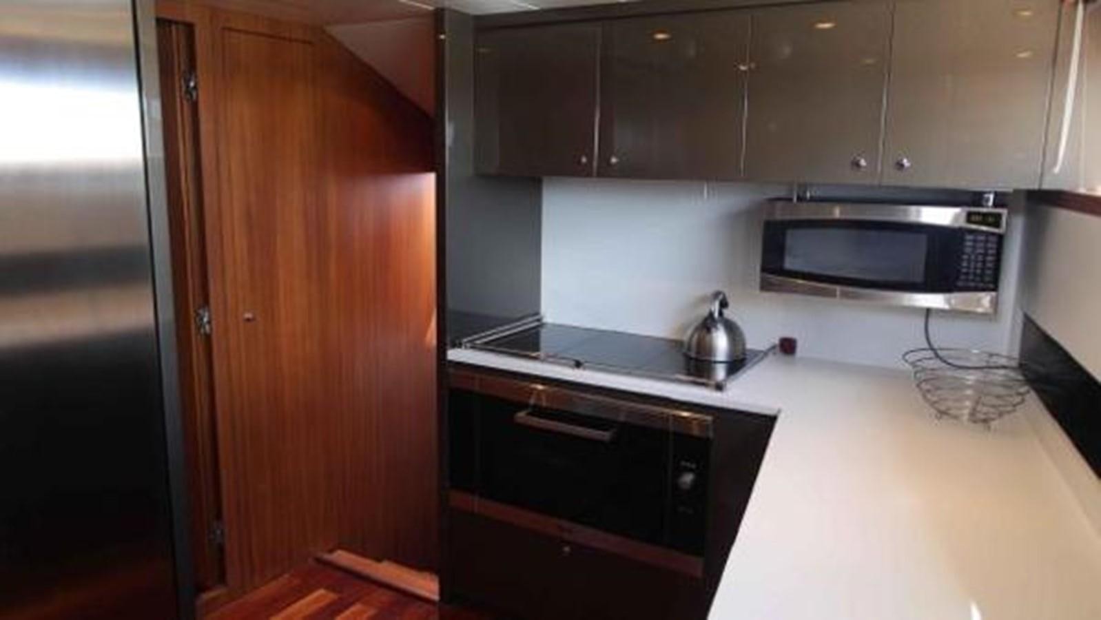 a kitchen with a microwave oven and a refrigerator aboard PRIVILEGIO Yacht for Sale