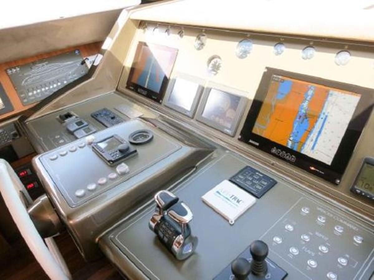 a control room with a few monitors and electronics aboard PRIVILEGIO Yacht for Sale
