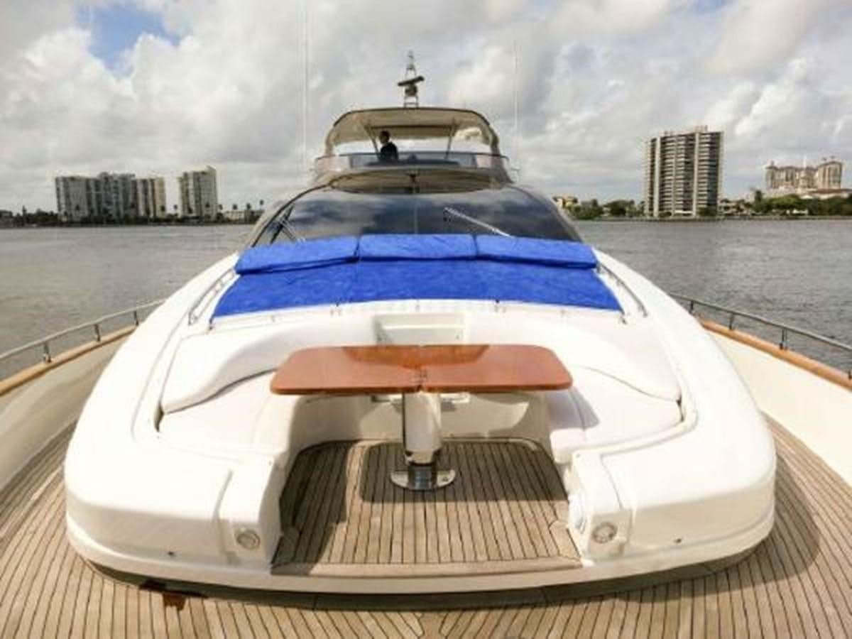 a white and blue boat on a wooden dock by a body of water aboard PRIVILEGIO Yacht for Sale
