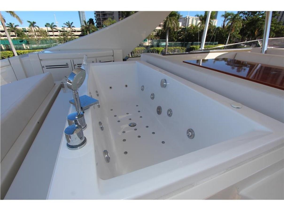 a white boat with a water tap aboard PRIVILEGIO Yacht for Sale