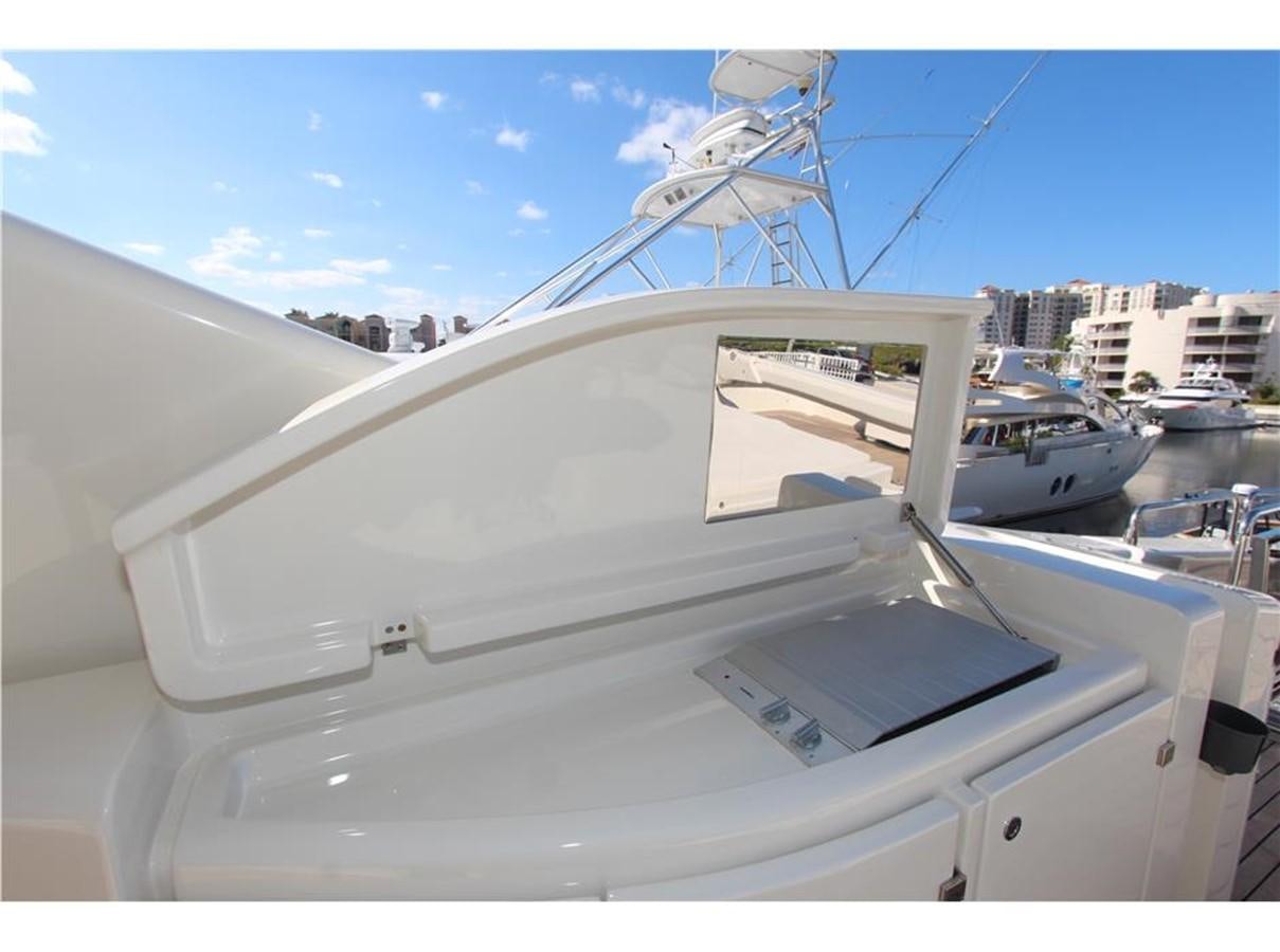 a white boat in a harbor aboard PRIVILEGIO Yacht for Sale
