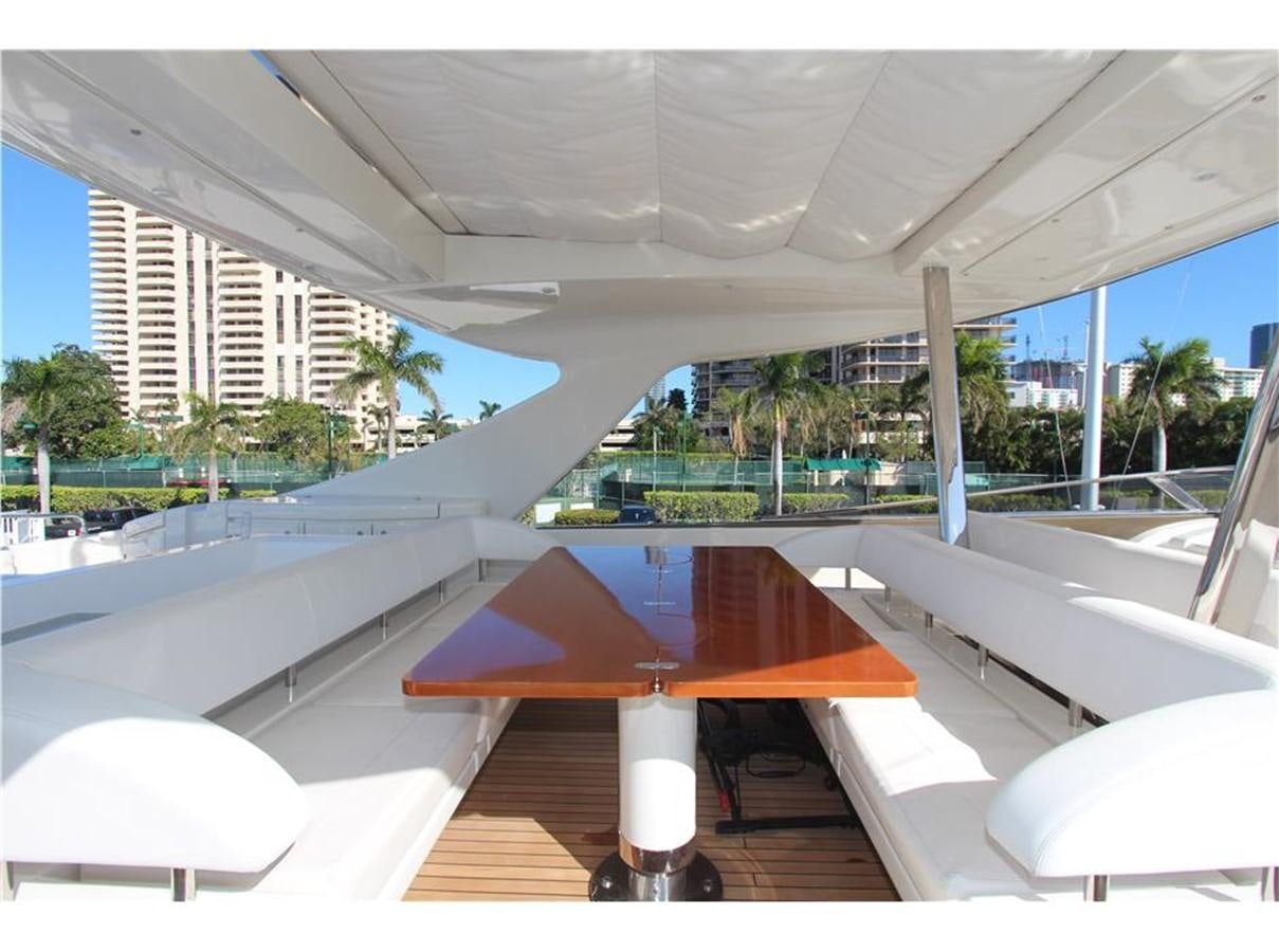 a pool with a table and chairs aboard PRIVILEGIO Yacht for Sale