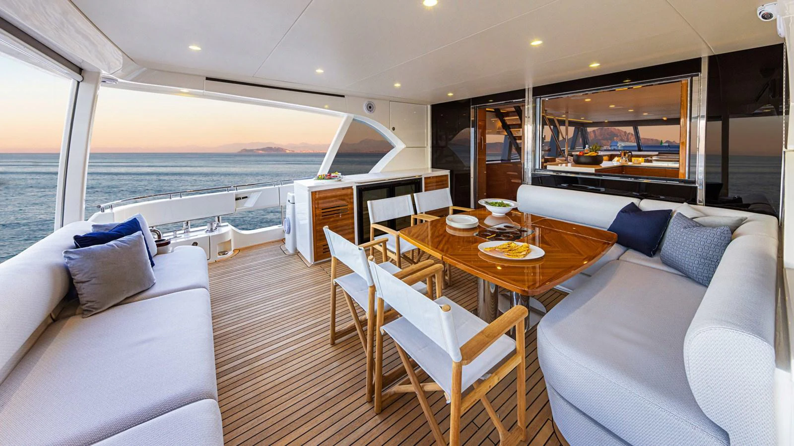 a room with a table and chairs aboard 78 MOTOR YACHT ENCLOSED Yacht for Sale