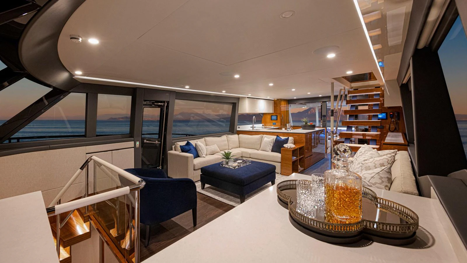 a living room with a large glass coffee table and a large window aboard 78 MOTOR YACHT ENCLOSED Yacht for Sale