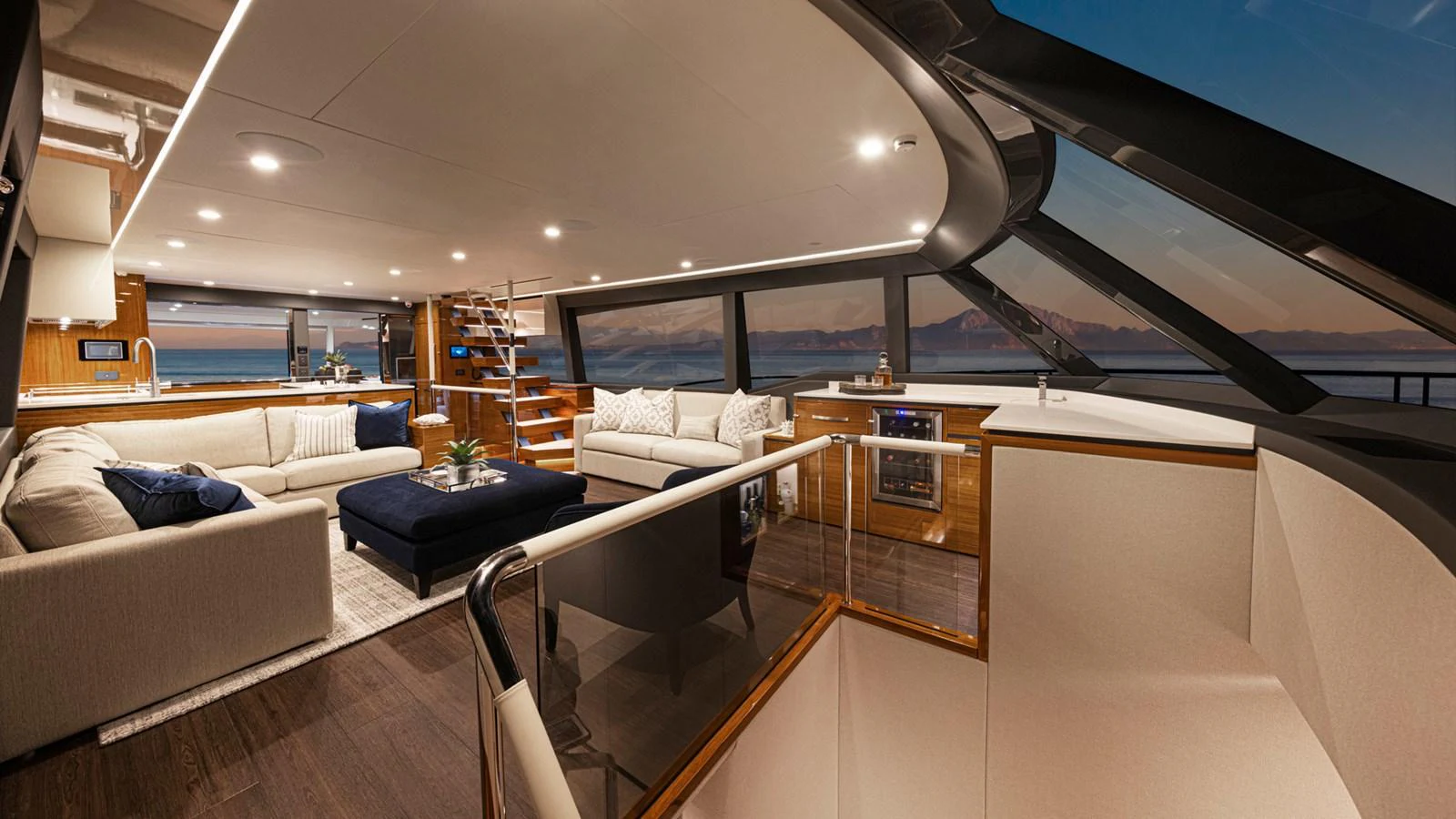 a room with a couch and a table aboard 78 MOTOR YACHT ENCLOSED Yacht for Sale