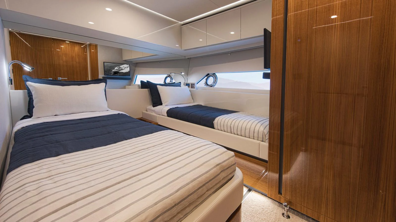 a room with a bed and a television aboard 78 MOTOR YACHT ENCLOSED Yacht for Sale