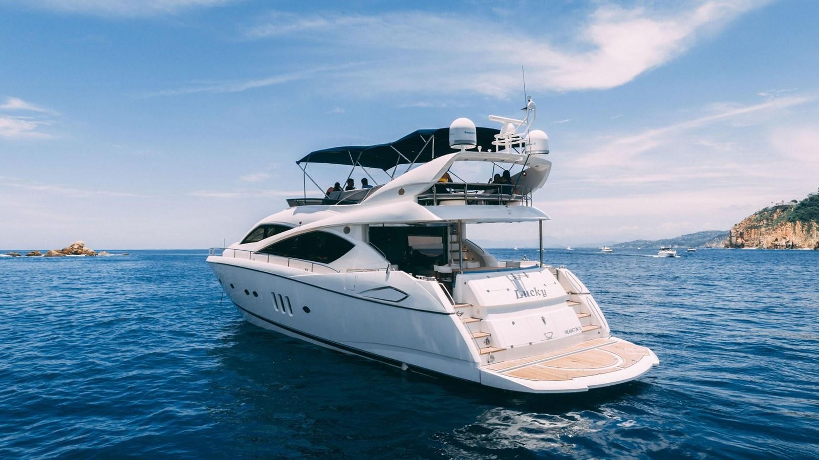 a white yacht in the water aboard LUCKY BEAR Yacht for Sale