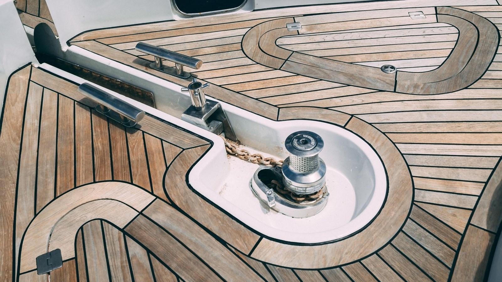 a wooden table with a metal object on it aboard LUCKY BEAR Yacht for Sale