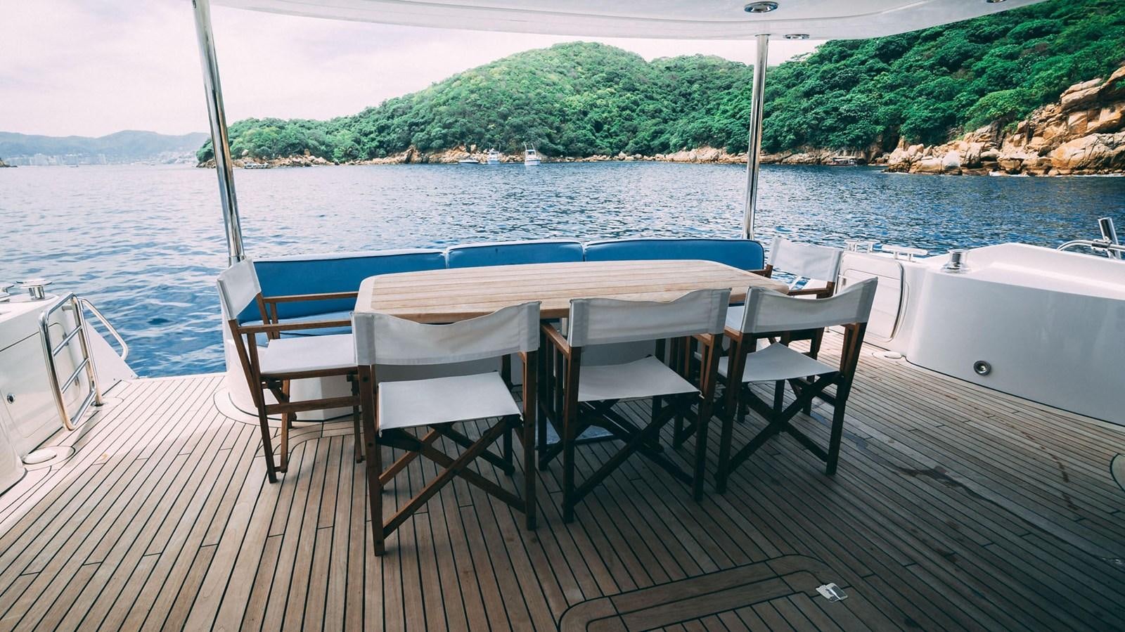 a table and chairs on a boat aboard LUCKY BEAR Yacht for Sale