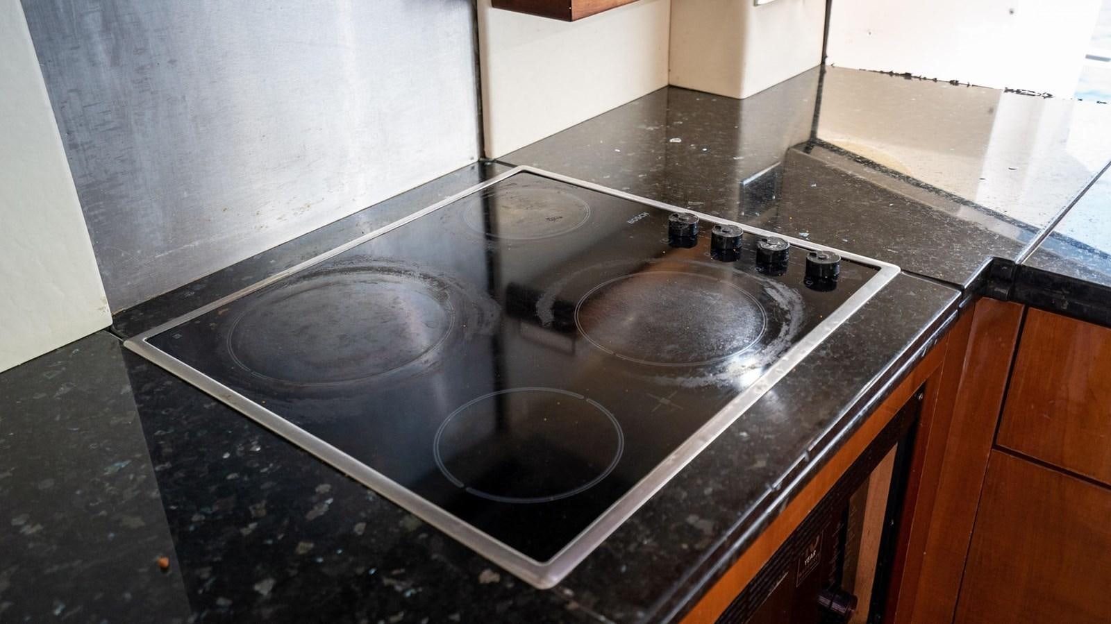 a kitchen with a marble counter top aboard LUCKY BEAR Yacht for Sale