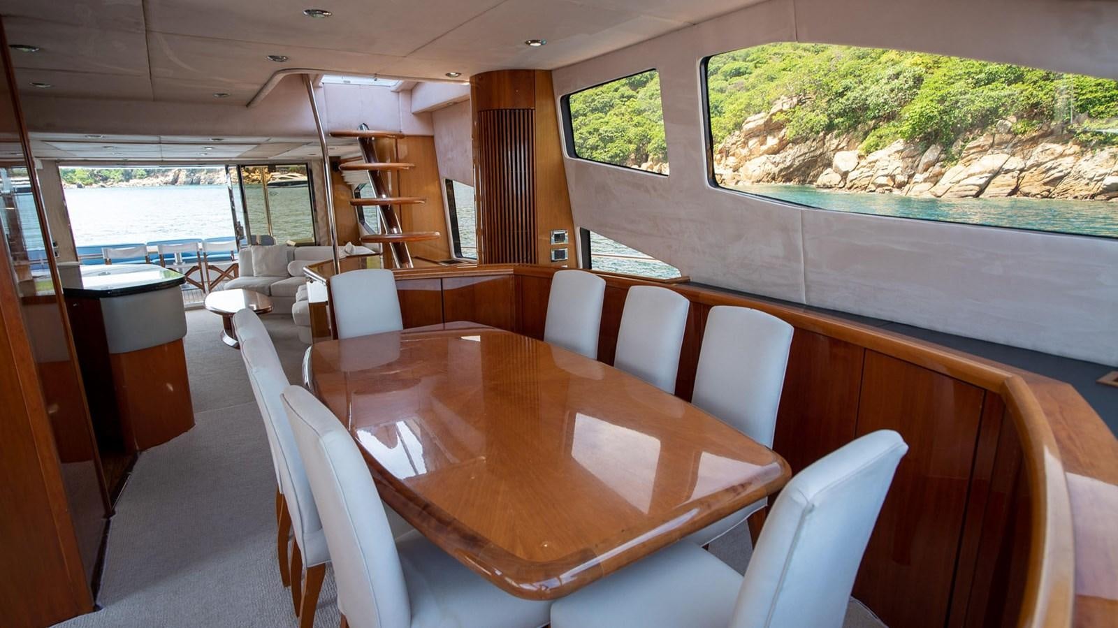 a table with chairs around it aboard LUCKY BEAR Yacht for Sale