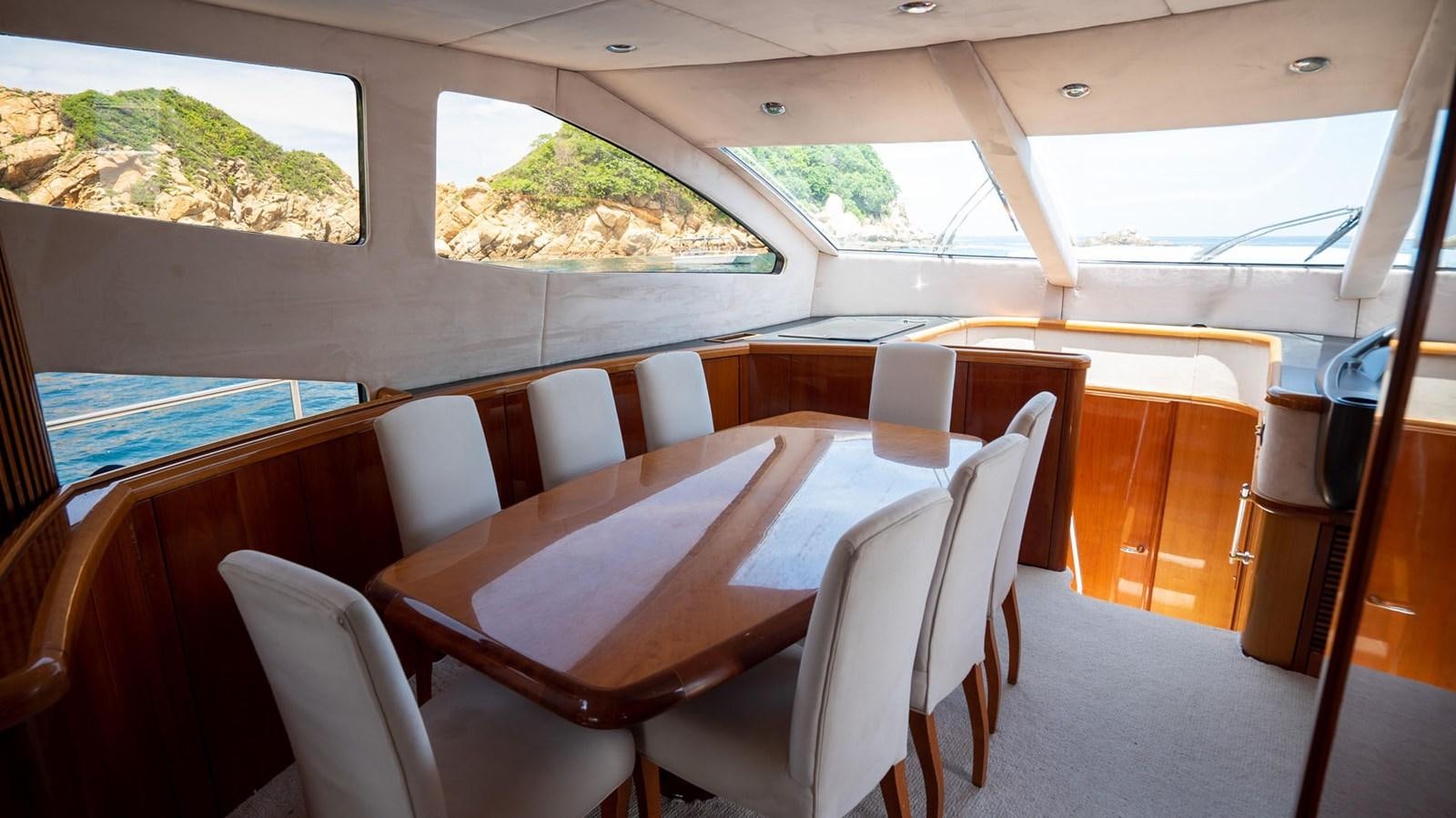 a room with a table and chairs aboard LUCKY BEAR Yacht for Sale