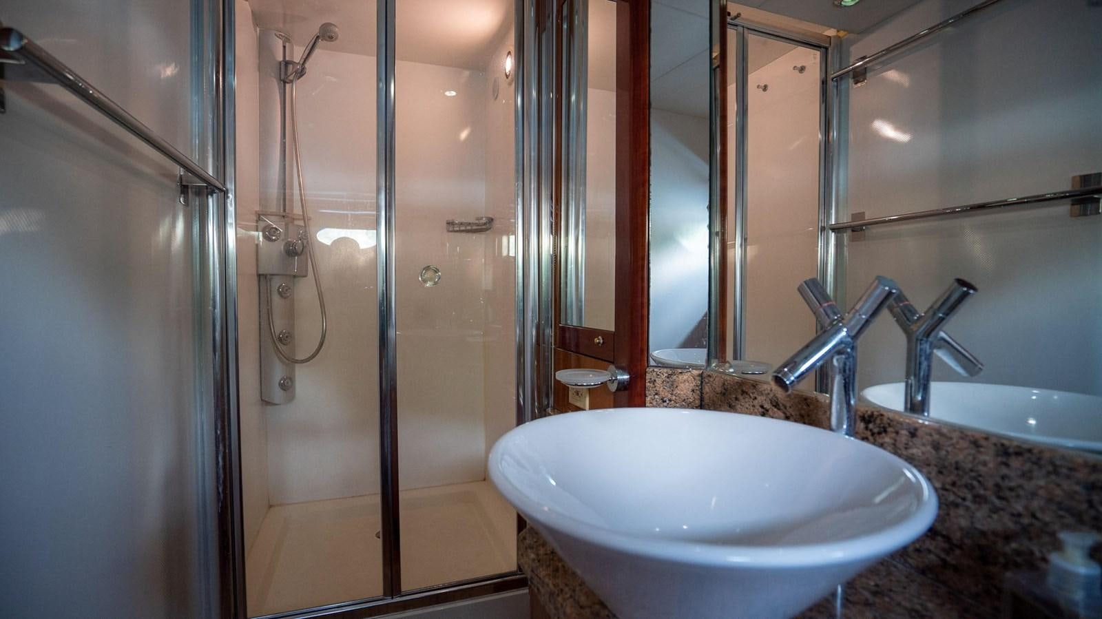 a bathroom with a sink and shower aboard LUCKY BEAR Yacht for Sale